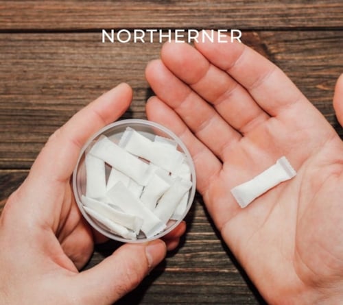 hand holds nicotine pouches, investigating ingredients of nicotine pouches