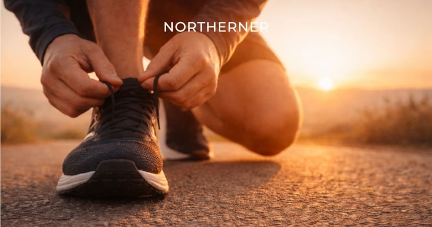 A runner ties up shoelaces on the ground