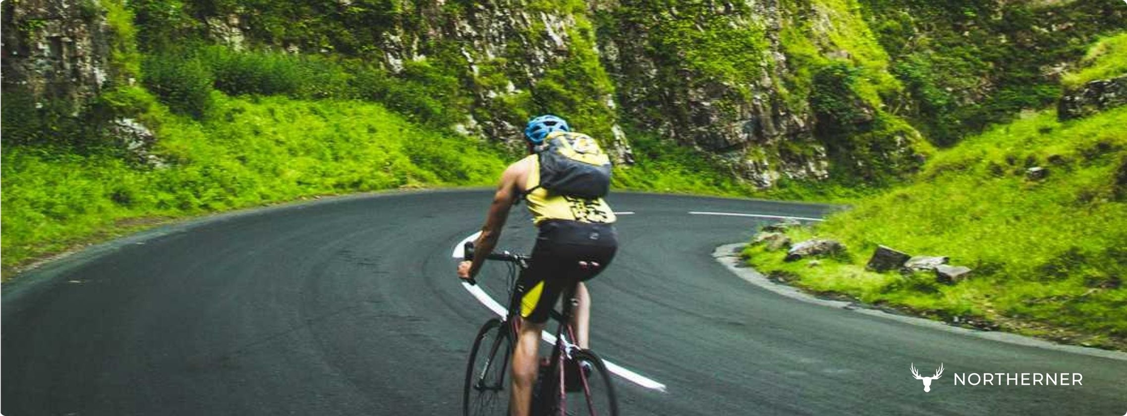 A person bikes in nature, highlighting how caffeine pouches can help with endurance training