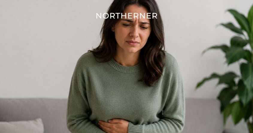 Woman holds her stomach, feeling queasy